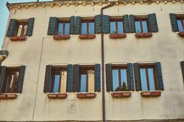Tourist walking through narrow Venetian streets contemplating the scenic canals and traditional gondolas in Venice Italy
