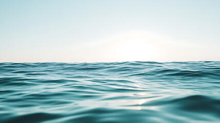 Horizon over the open ocean, clear skies above gentle waves. The sun is setting, creating a tranquil scene. Light reflects on the water. A serene seascape moment.