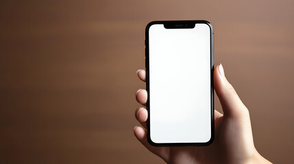A hand holding a smartphone against a brown background. The screen is white, offering space for content or design elements. Perfect for app, website, or graphic design mockups.
