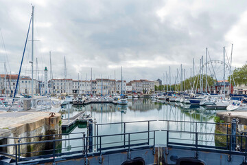 La Rochelle in Charente-Maritime - Tidal basin in the center of La Rochelle between the old port and Quai Valin with a view of a lighthouse embedded along a row of houses