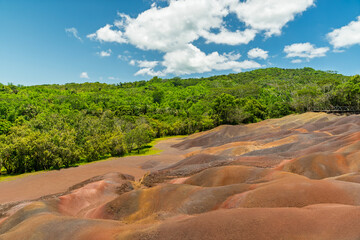 Chamarel Black River Mauritius wide panorama of rainbow dunes and tropical forest under bright blue sky