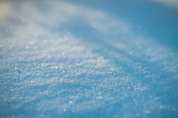 Obraz premium Freshly fallen snow creates a bright winter background with countless sparkling crystals reflecting sunlight, forming a cold abstract texture for seasonal designs