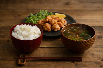 Japanese breakfast set on rustic wooden table with chicken karaage