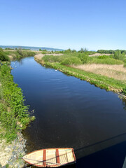 wooden boat on calm Zala river in green countryside next to lake Balaton