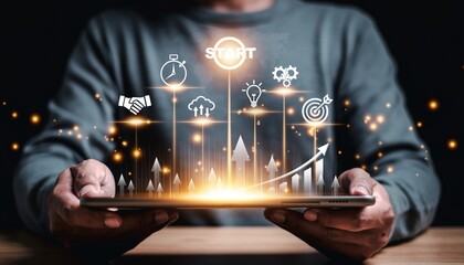 Hands hold a tablet with graphics showing progress, ideas, and goals in a dark setting, creating a modern scene of technology and innovation
