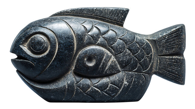Inuit carved soapstone animal sculpture with smooth dark texture, isolated on a white background
