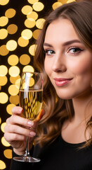 Young woman with long hair, wearing in dress, holds a champagne glass, celebrating in front of beautifully decorated Christmas tree with warm bokeh lights, embodying festive joy and elegance