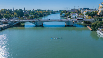Naklejka premium rowing through the city of Seville, Spain in the morning