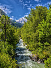 Obraz premium Dora baltea river flowing through Aosta valley mountains