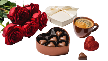 Valentine day romantic gift arrangement featuring red roses heart shaped chocolates and a cup of coffee isolated on white