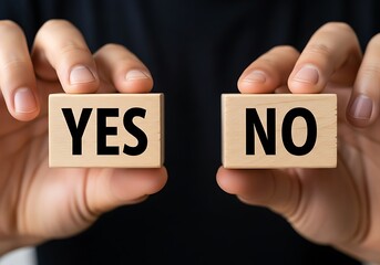 Human hands holding wooden blocks displaying yes and no decision making concepts