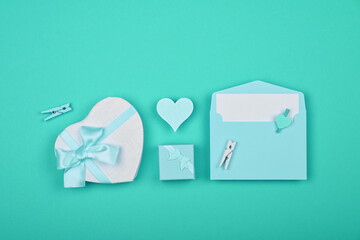 Valentine gift boxes and envelope over teal