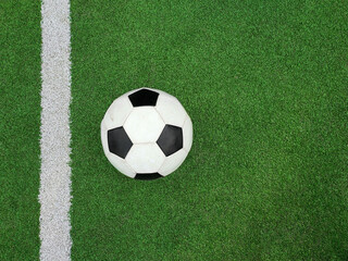 Football ball over green soccer field