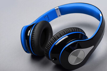 Close up modern blue headphones on gray table