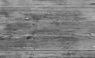 High-resolution grayscale background of aged wooden planks with visible grain, knots, and horizontal lines, ideal for rustic design, branding, or editorial use.