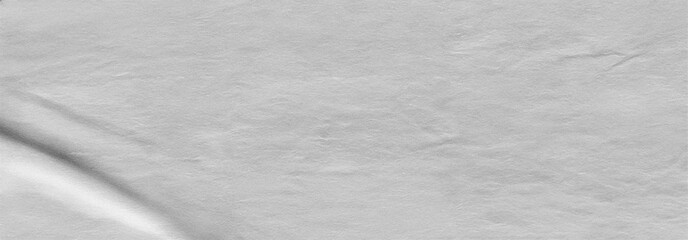 Close-up of soft white fibrous paper texture with visible fibers and a gentle crease shadow. Ideal for tactile backgrounds, eco design, print mockups, and minimal visuals.