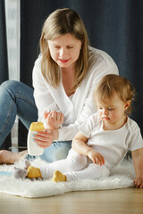 Pretty woman blowing candlelight on a chocolate donut, happy birthday celebration. 