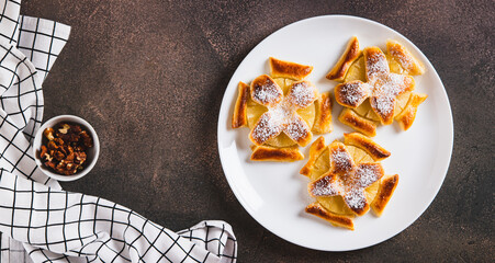 Mini baked pineapple tarts on a plate on the table top view web banner
