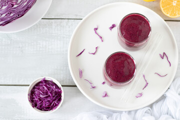 Red cabbage lemon smoothie on a kitchen table. Top view. Healthy detox blended drink.