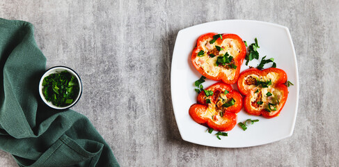 Fried bell pepper rings with sausages, tomatoes and egg on a plate top view web banner