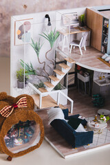 A close-up of the stairs to the second floor in a dollhouse vertical view