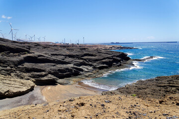 Rocky Tenerife coast around Montana Bocinegro and Montana Roja mountain, near El Medano, Canary Islands, Spain, sunny summer day