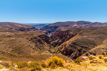 A view from the Swartberg Pass towards a deep ravine in the Swartberg mountains in South Africa in springtime