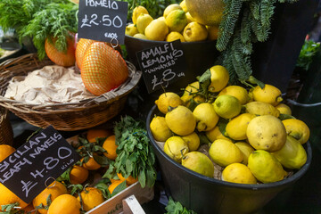 London, UK, December 2, 2025, Fresh organic lemons and pomelos displayed with price tags at a...