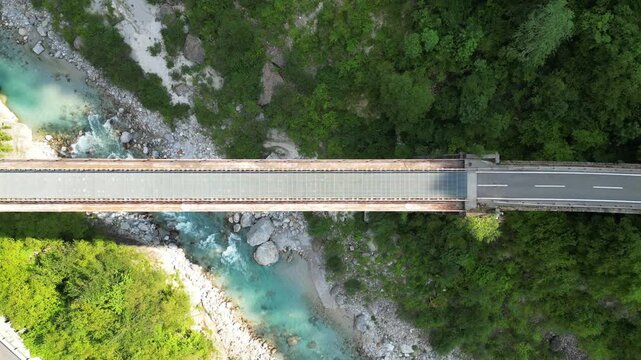 Alpine mountain valley with bridge and river at the Alpe Adria bicycle trail