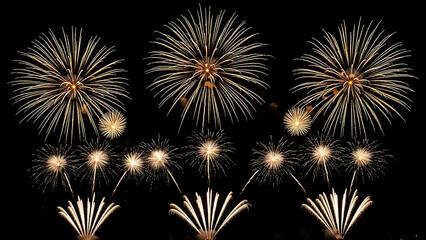 Fototapeta premium golden fireworks explode in the dark night sky creating a brilliant display for new years eve and general festive celebrations.