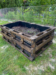 wooden pallet raised garden bed with twig layer