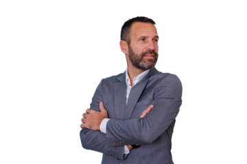 Confident businessman standing with arms crossed, thinking with pensive expression, wearing gray suit, transparent background