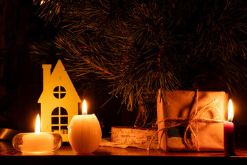 New Year's tree, candles, and a gift wrapped in kraft paper with the Ukrainian flag, a warm, homely glow, a symbol of comfort, hope