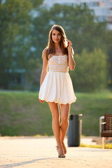 Slavic Woman Walking in Sunlit Urban Park