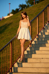 Slavic Woman in White Dress on Staircase