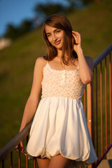Slavic Woman in White Dress on Staircase