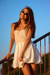 Slavic Woman in White Dress on Railing