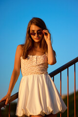 Slavic Woman in White Dress on Railing