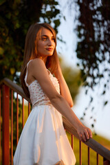 Slavic Woman in White Dress on Staircase