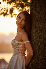 Slavic Woman in Lace Dress by Tree
