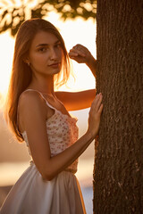 Slavic Woman in Lace Dress by Tree