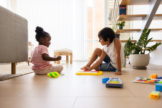 Multiethnic children playing with educational toys at home