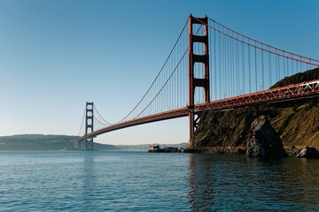 Obraz premium Golden Gate Bridge stands tall over water on a clear day in San Francisco Bay