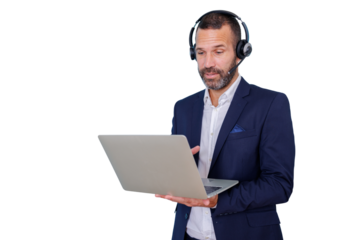 Businessman wearing a headset with microphone, looking at a laptop computer while engaging in a virtual business call. Transparent background