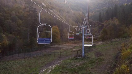 An empty chairlift climbs to the top of the mountain.