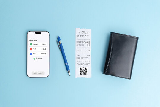 Smartphone displaying expenses overview dashboard next to paper receipt on blue background, illustrating modern finance app, bookkeeping software, business analytics, and digital expense management - Powered by Adobe