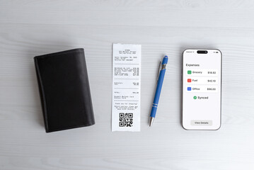Personal finance flat lay with smartphone, wallet, receipt and pen on white desk, expense management and payment tracking concept for business and consumer use