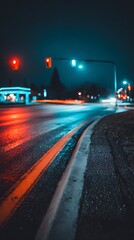 Nighttime cityscape. Street with wet asphalt reflecting red and blue traffic lights. Blurred lights