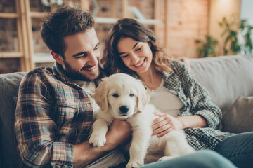 Couple enjoys cozy moments with their new golden retriever puppy