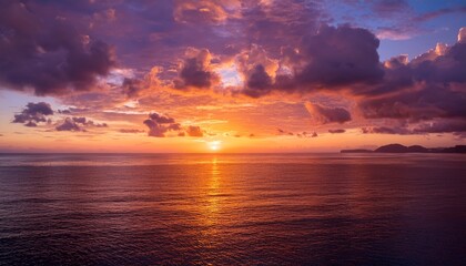Majestic Sunset Over A Tranquil Ocean Featuring A Vibrant And Dramatic Cloudscape Painting The Sky With Brilliant Orange Yellow And Pink Hues A Serene Natural Landscape At Dusk